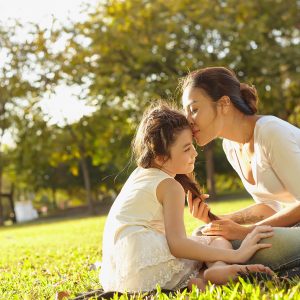 Lifestyle portrait mom and daughter in happines at the outside in the meadow